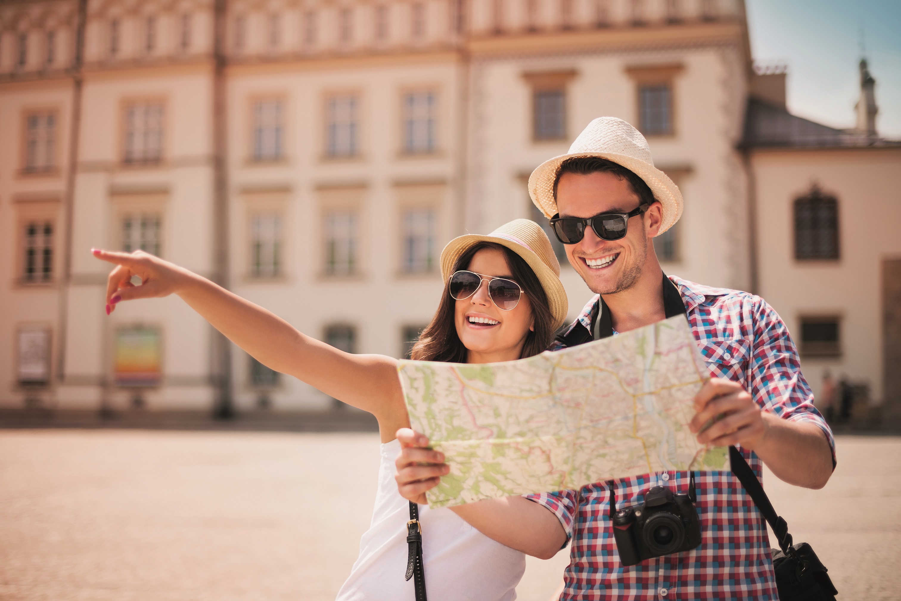 	A man and a woman, as tourists look at the map 
